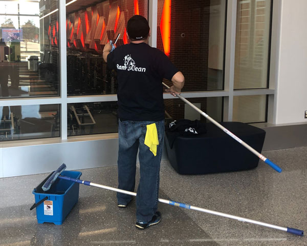 RamClean Employee cleaning window