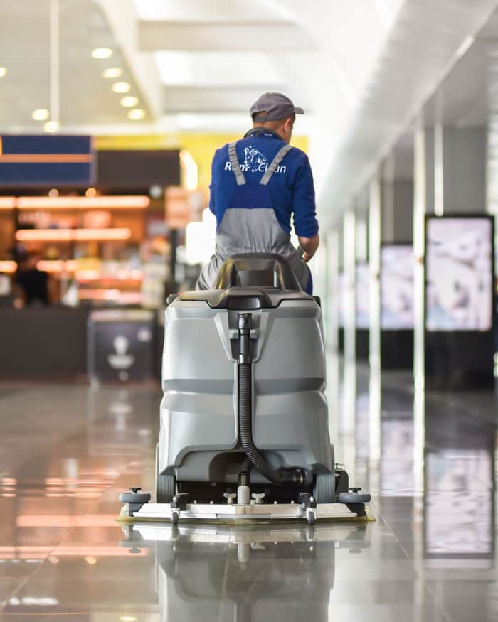 RamClean employee on floor scrubber