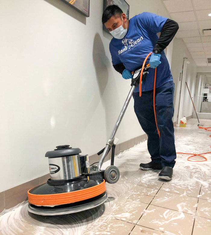 RamClean employee cleaning floor