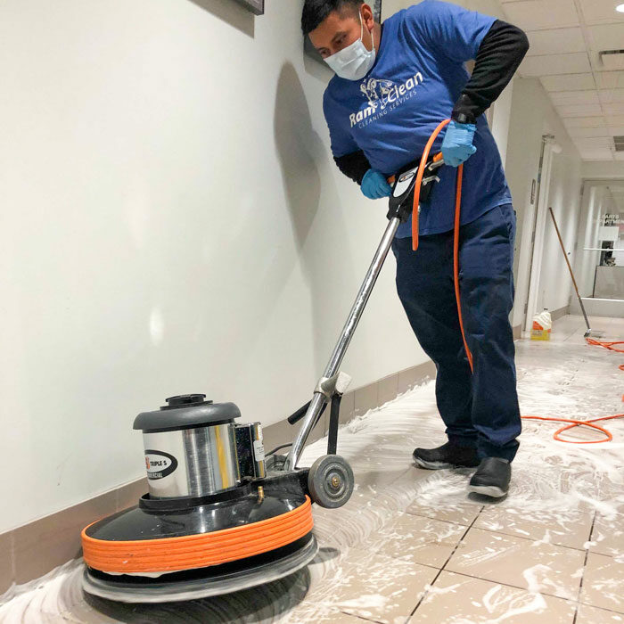 RamClean employee cleaning floor